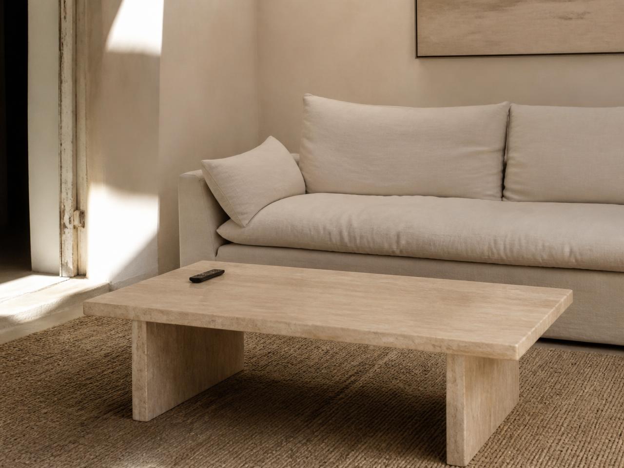 The same living room before styling — just a bowl and remote on the coffee table